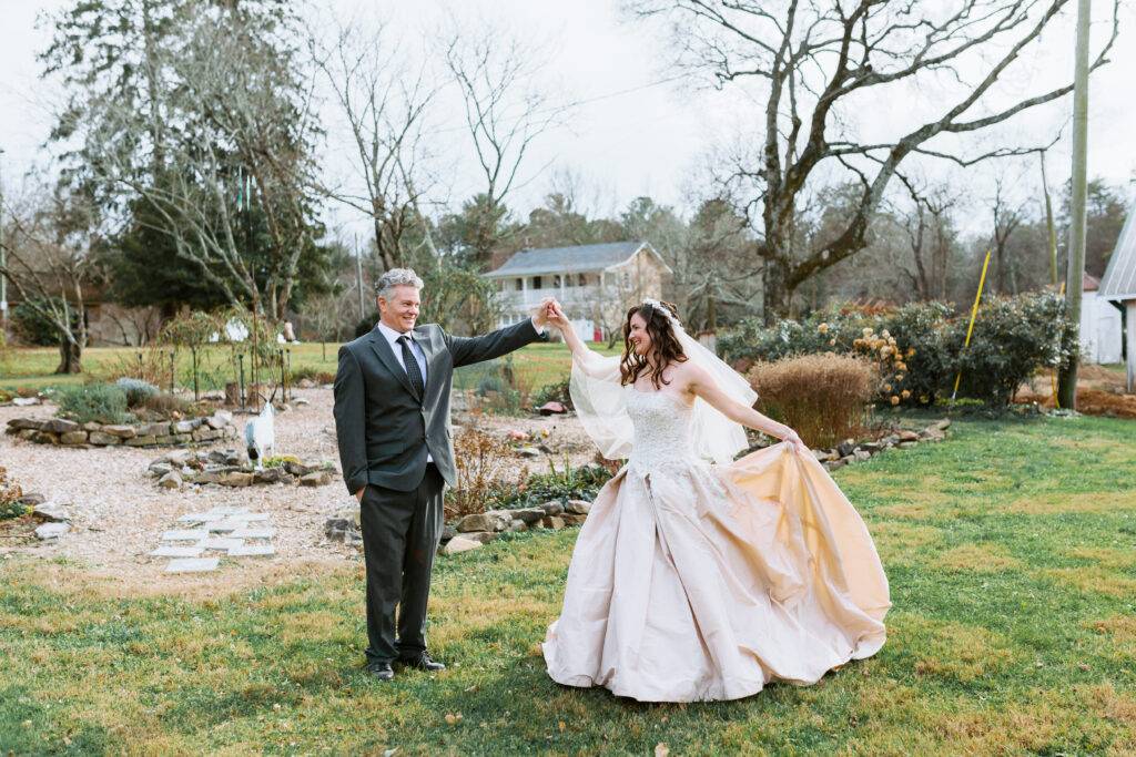 dad and bride dancing outside