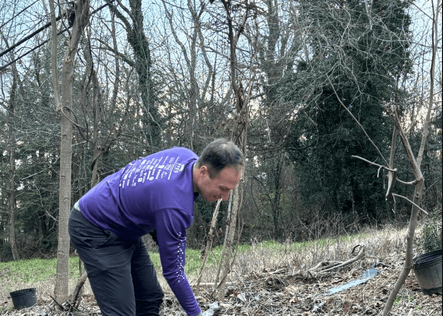 Grounds Group volunteer clearing invasive plants at McCoy