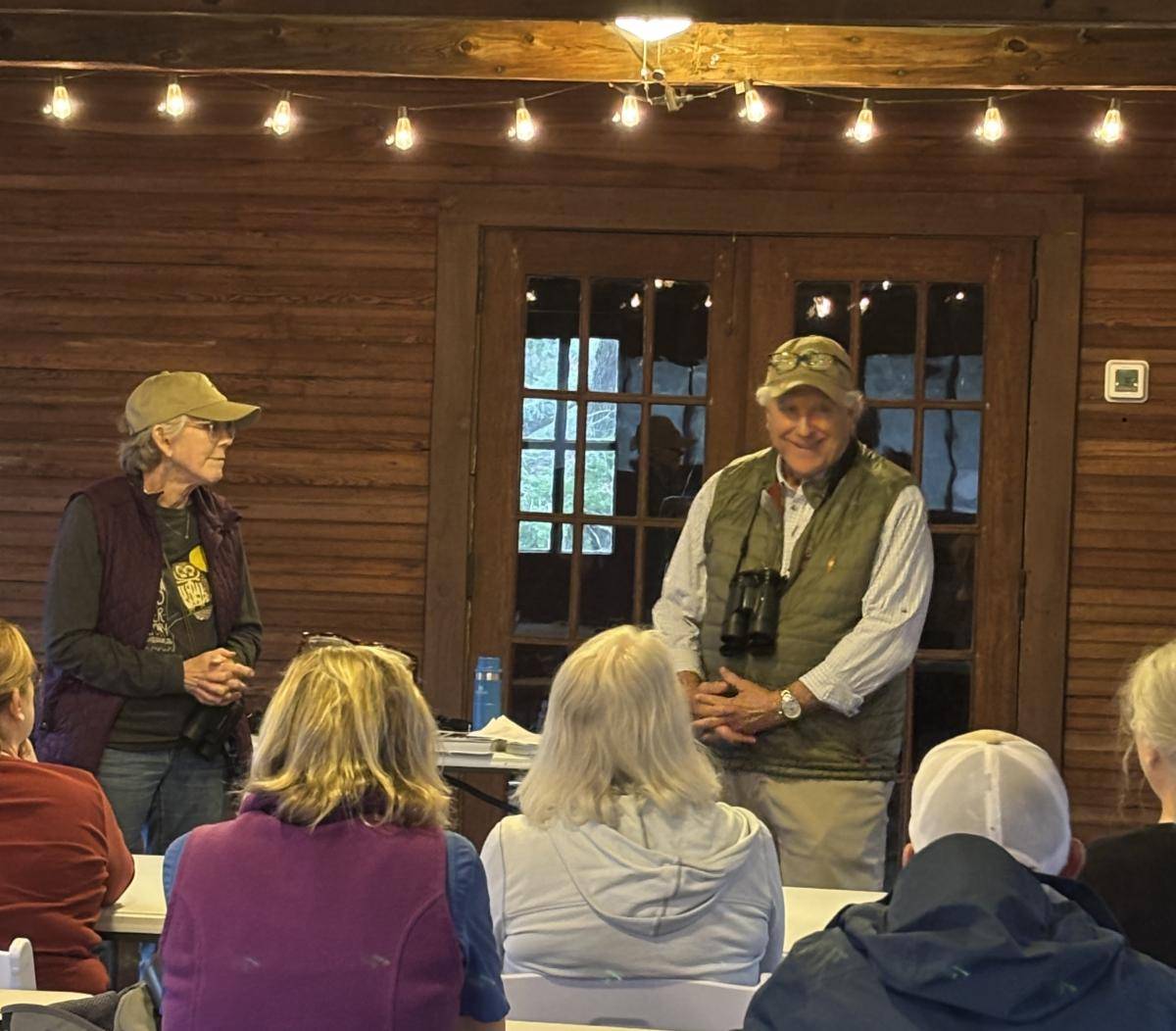 Birding 101 instructors speaking to a seated group in the Pavilion