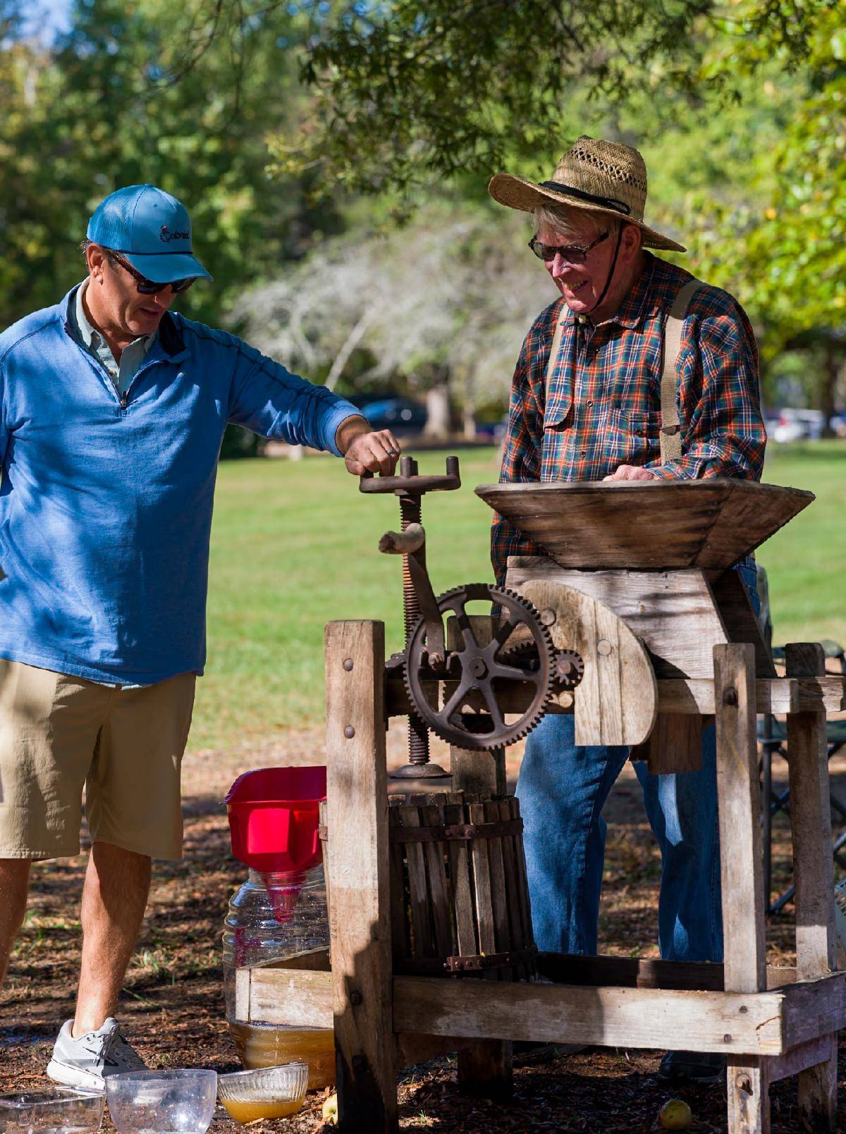 Mickey Robbins demonstrating a cider press at McCoy Farm and Gardens